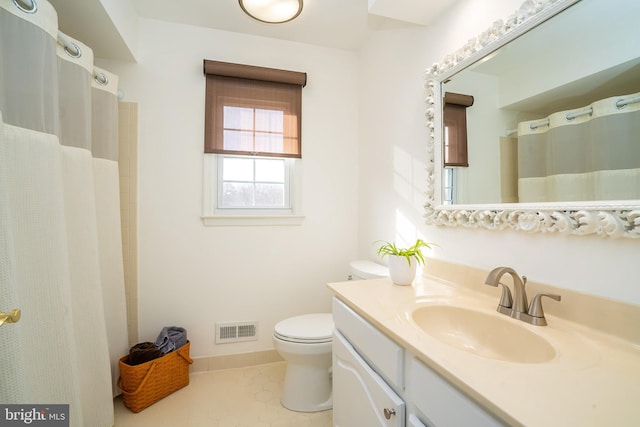 bathroom featuring baseboards, visible vents, toilet, tile patterned flooring, and vanity