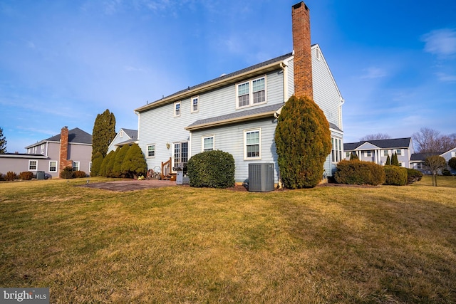 back of property with a residential view, a patio area, a lawn, and central air condition unit