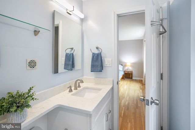 bathroom with vanity and wood finished floors