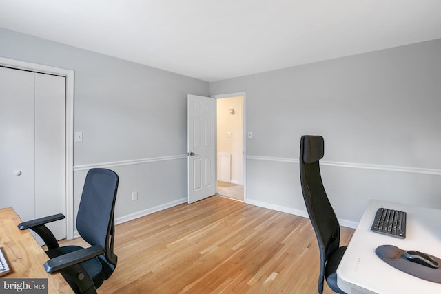 office space with light wood finished floors and baseboards