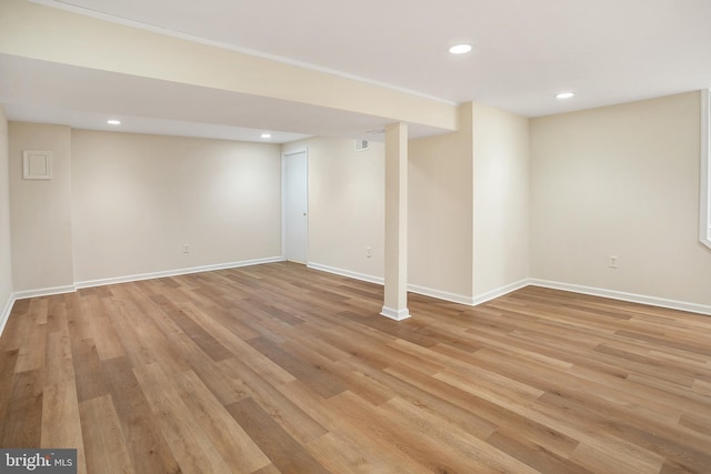 finished below grade area with recessed lighting, light wood-style floors, and baseboards