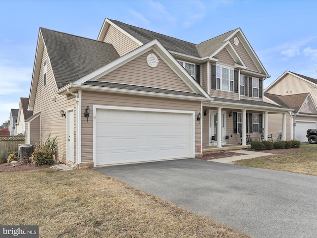 view of front of house with aphalt driveway, an attached garage, covered porch, a shingled roof, and a front yard