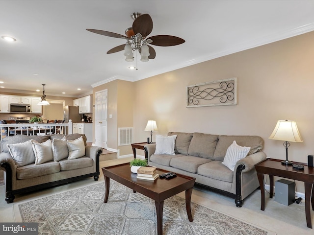 living room with ceiling fan, recessed lighting, visible vents, baseboards, and ornamental molding