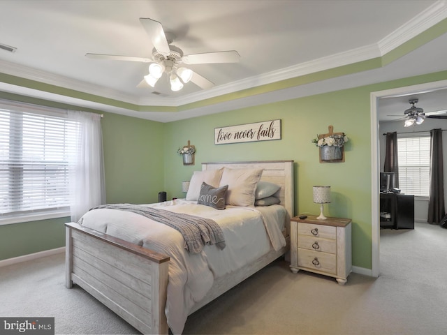 bedroom with baseboards, ornamental molding, multiple windows, and light colored carpet