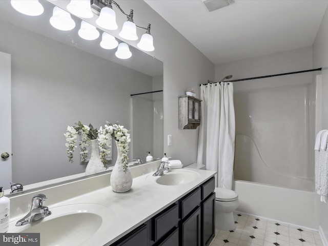 full bath with double vanity, shower / bath combo with shower curtain, a sink, and visible vents