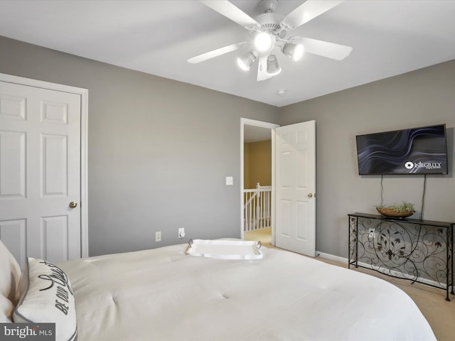 bedroom with light colored carpet and ceiling fan