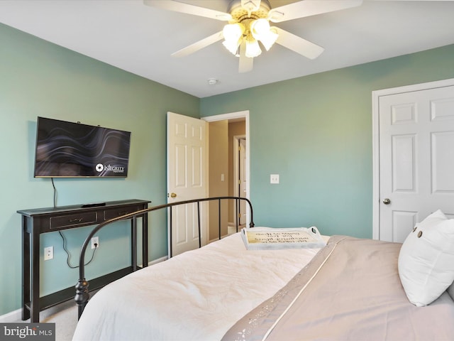 bedroom with baseboards and a ceiling fan