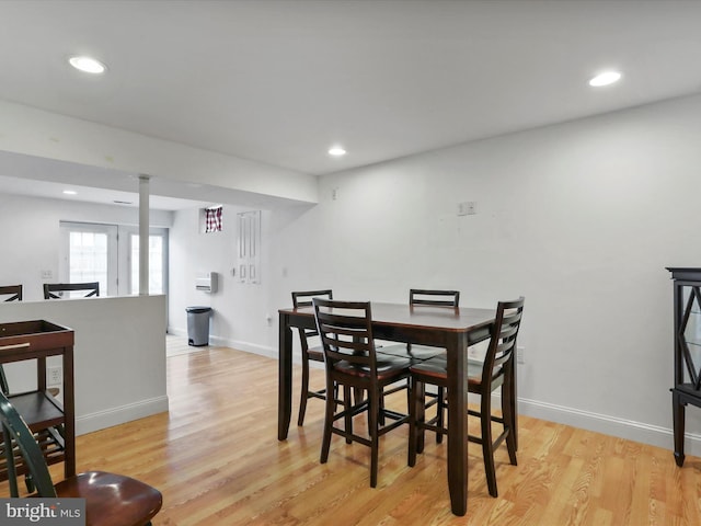 dining space with light wood-style flooring, baseboards, and recessed lighting