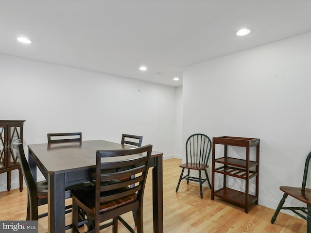 dining area featuring baseboards, light wood-style flooring, and recessed lighting