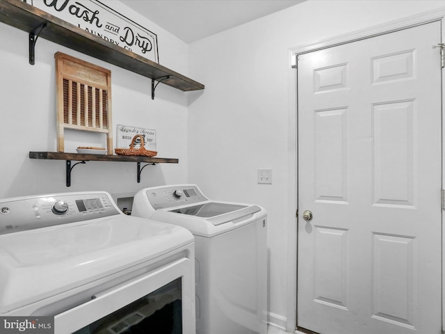 washroom featuring laundry area and washer and clothes dryer