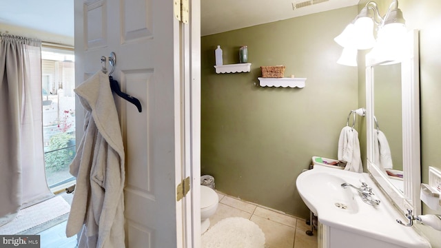 half bath with toilet, tile patterned flooring, visible vents, and vanity