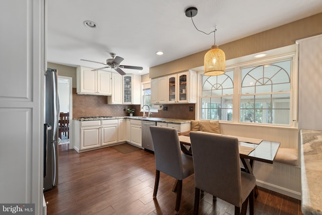 kitchen with white cabinetry, glass insert cabinets, stainless steel appliances, and dark wood finished floors