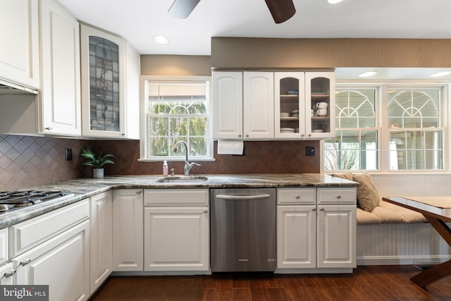 kitchen featuring dark wood-style flooring, white cabinets, a sink, and dishwasher