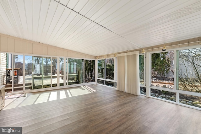 unfurnished sunroom with lofted ceiling