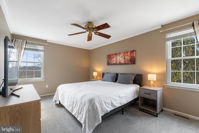 bedroom with ornamental molding, carpet, visible vents, and baseboards