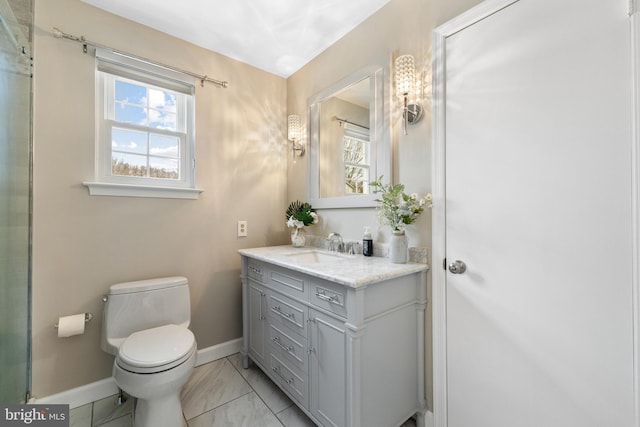 bathroom featuring marble finish floor, vanity, toilet, and baseboards