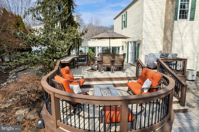 wooden deck featuring an outdoor fire pit and outdoor dining space