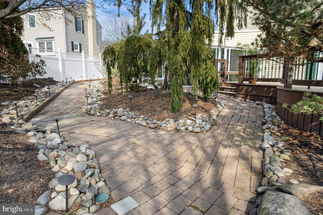 exterior space with a patio area, fence, and a wooden deck