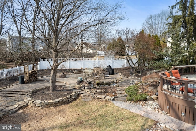 view of yard with a patio, a fenced backyard, and a wooden deck