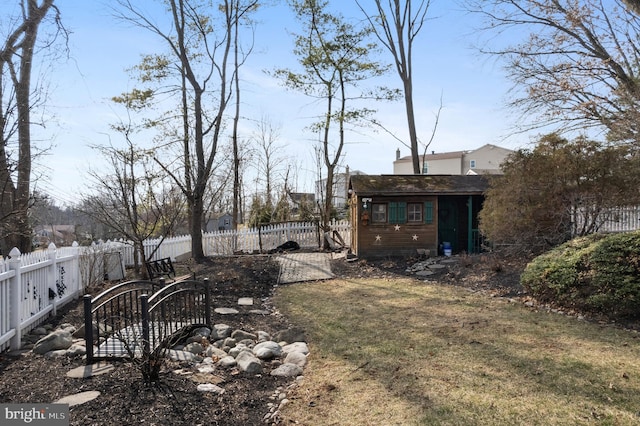 view of yard with a fenced backyard and an outdoor structure