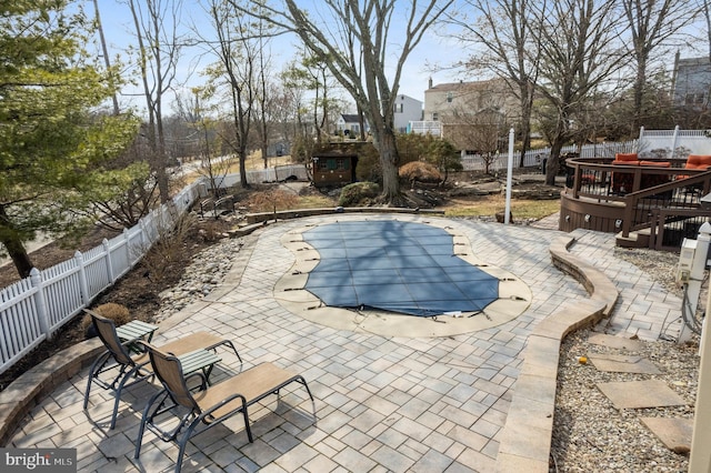 view of pool featuring a fenced backyard, a fenced in pool, and a patio