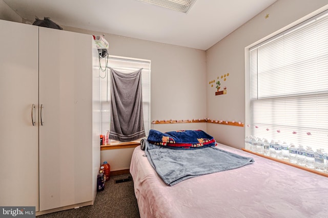 carpeted bedroom featuring baseboards