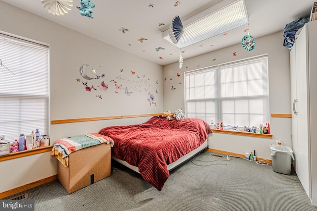 carpeted bedroom featuring baseboards