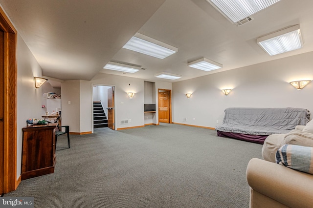 carpeted living room featuring visible vents, stairway, and baseboards