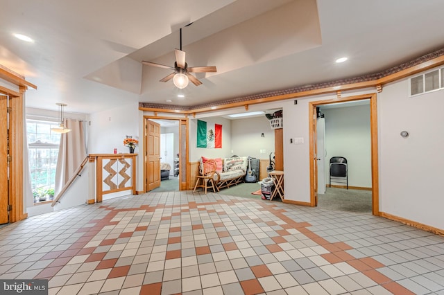 interior space featuring baseboards, visible vents, a ceiling fan, an upstairs landing, and recessed lighting