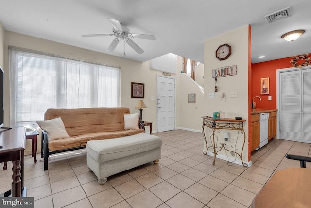 living area with visible vents, ceiling fan, baseboards, and light tile patterned flooring