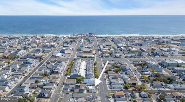 drone / aerial view featuring a view of city and a water view