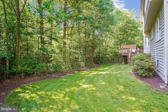 view of yard featuring stairway and a wooden deck