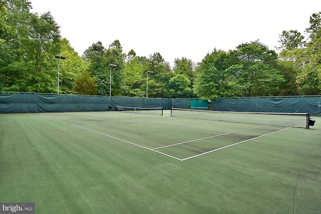 view of tennis court with fence