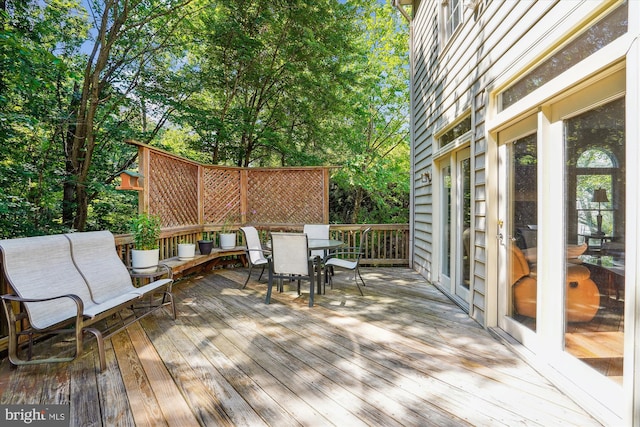 wooden deck featuring outdoor dining area