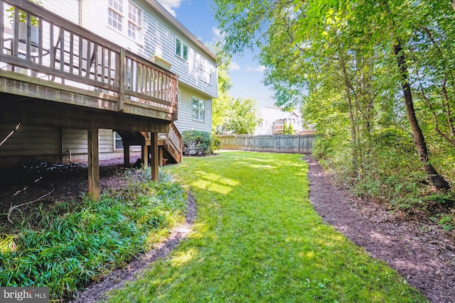 view of yard featuring stairs, a deck, and fence