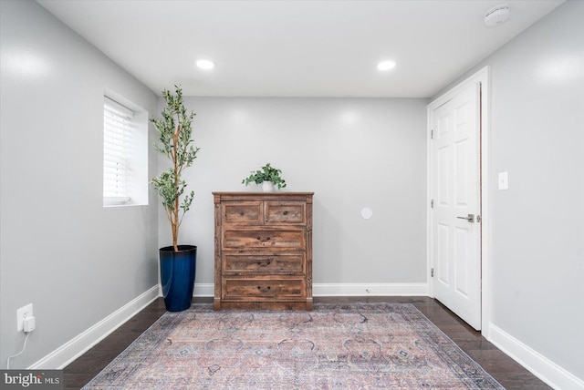 interior space featuring dark wood-type flooring, recessed lighting, and baseboards