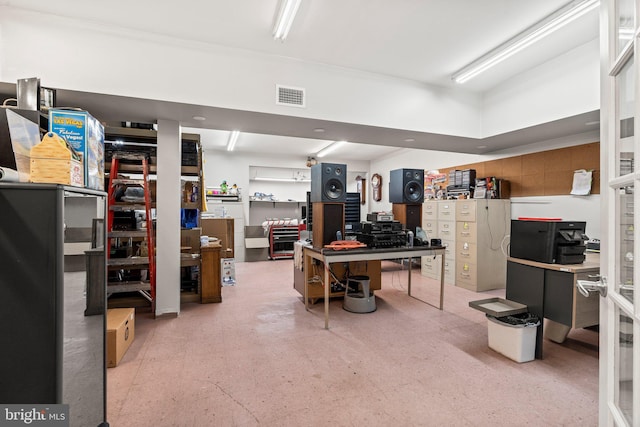 interior space featuring light floors, visible vents, and a workshop area