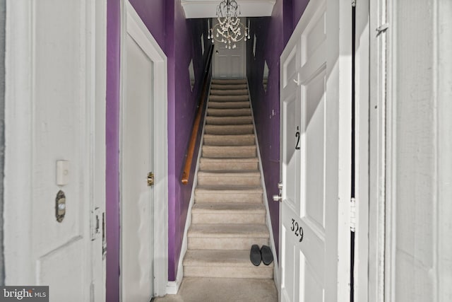 stairway with an inviting chandelier