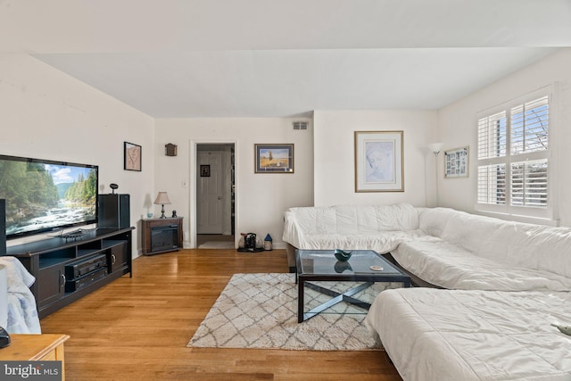 living area featuring light wood-style floors and visible vents