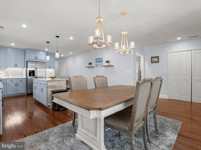 dining room with recessed lighting, visible vents, dark wood-type flooring, and a chandelier