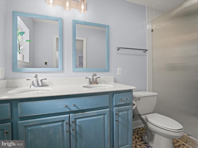 full bathroom featuring double vanity, toilet, and a sink