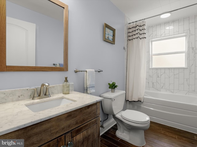 bathroom featuring shower / bath combo, toilet, vanity, and wood finished floors