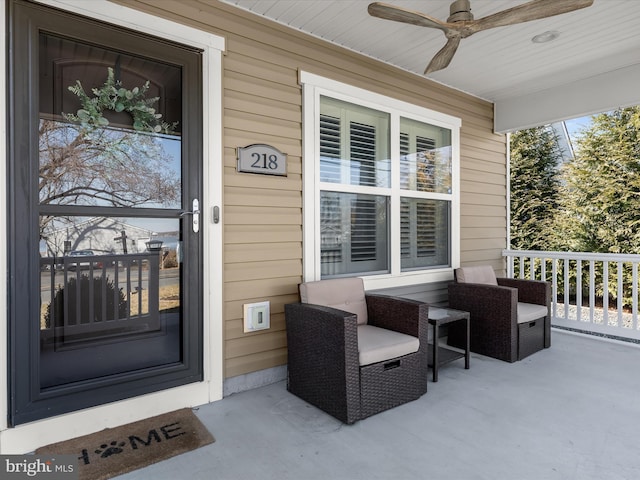 entrance to property featuring covered porch and a ceiling fan