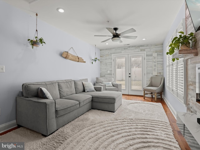 living room with a ceiling fan, wood finished floors, baseboards, recessed lighting, and french doors