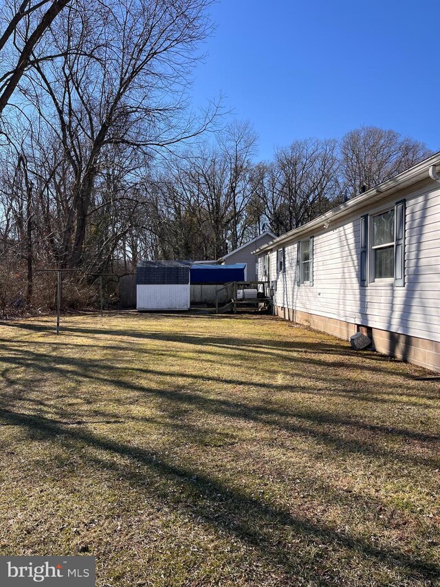 112 Mitchell St, Saint Michaels, MD 21663 - view of home's exterior featuring an outbuilding, a lawn, and a storage shed