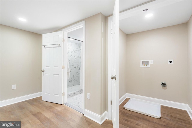 laundry area with laundry area, baseboards, hookup for a washing machine, hookup for an electric dryer, and light wood-type flooring