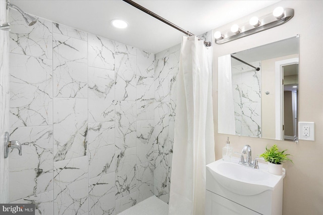 full bathroom featuring a shower stall and vanity