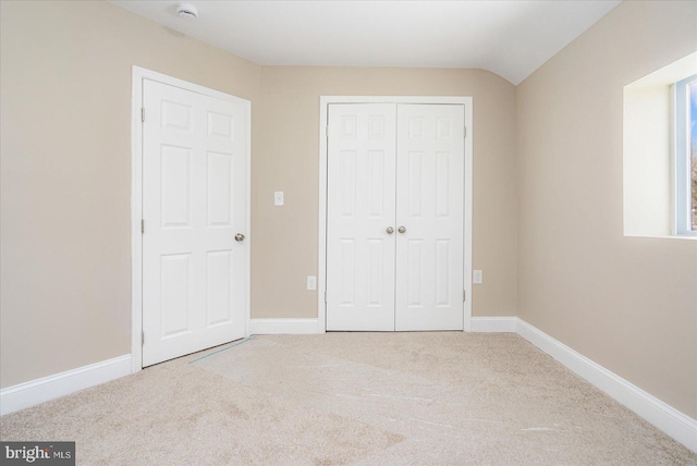 unfurnished bedroom featuring a closet, carpet flooring, and baseboards