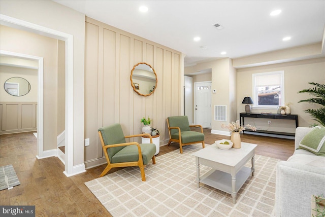 living room featuring light wood-style floors, recessed lighting, and visible vents