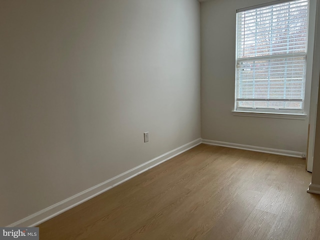 empty room featuring light wood-style flooring and baseboards